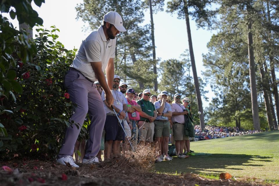 Scottie Scheffler hits from the pine straw on the 10th hole during third round at the Masters golf tournament at Augusta National Golf Club Saturday, April 13, 2024, in Augusta, Ga. (AP Photo/George Walker IV)