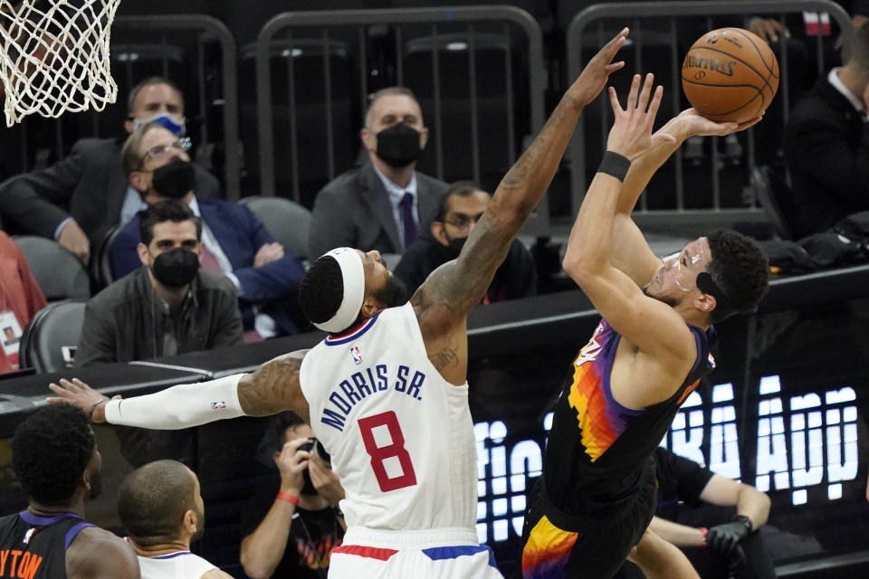 Phoenix Suns guard Devin Booker (1) shoots over Los Angeles Clippers forward Marcus Morris Sr. (8) during the second half of game 5 of the NBA basketball Western Conference Finals, Monday, June 28, 2021, in Phoenix. (AP Photo/Matt York)