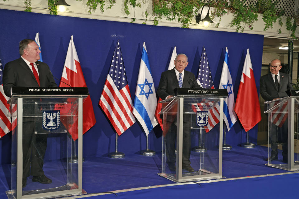 U.S. Secretary of State Mike Pompeo, left, and Bahrain's Foreign Minister Abdullatif bin Rashid Alzayani, right, listen as Israeli Prime Minister Benjamin Netanyahu speaks during a joint press conference after their trilateral meeting in Jerusalem on Wednesday, Nov. 18, 2020. (Menahem Kahana/Pool via AP)