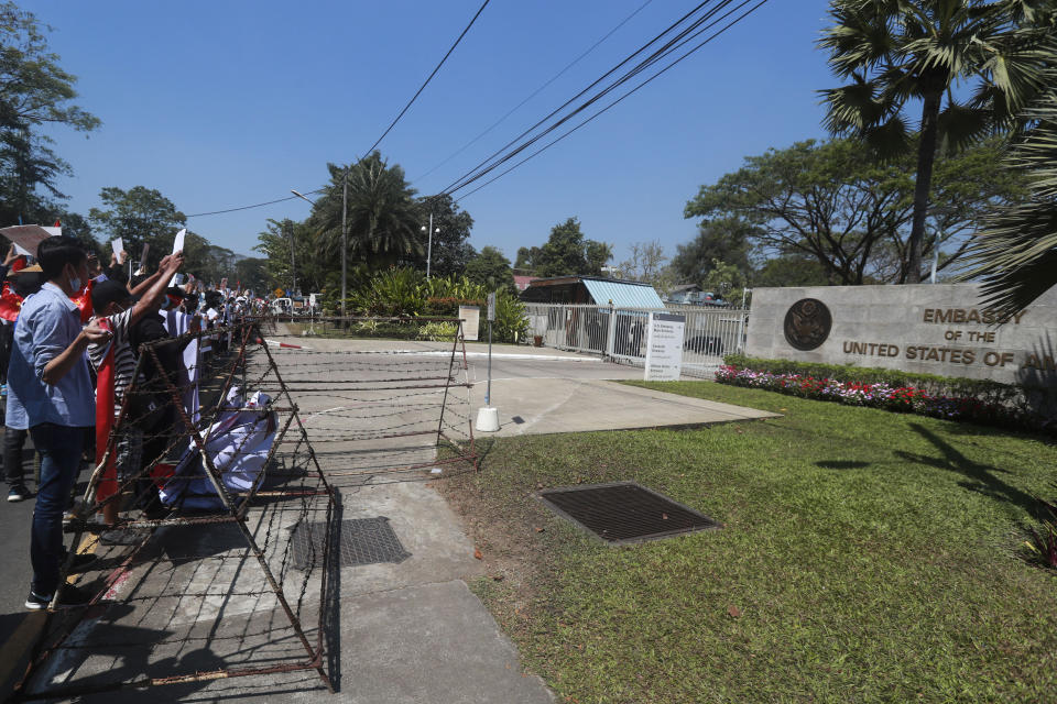 Anti-coup protesters gather outside U.S. Embassy in Yangon, Myanmar, Saturday, Feb. 13, 2021. Mass street demonstrations in Myanmar have entered their second week with neither protesters nor the military government they seek to unseat showing any signs of backing off from confrontations. (AP Photo)