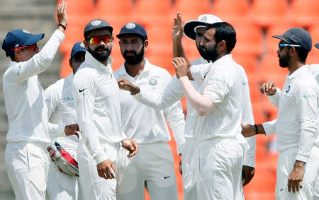 Cricket - Sri Lanka v India - Third Test Match - Pallekele, Sri Lanka - August 13, 2017 - India's Mohammed Shami celebrates with captain Virat Kohli and his teammates after taking the wicket of Sri Lanka's Upul Tharanga. REUTERS/Dinuka Liyanawatte