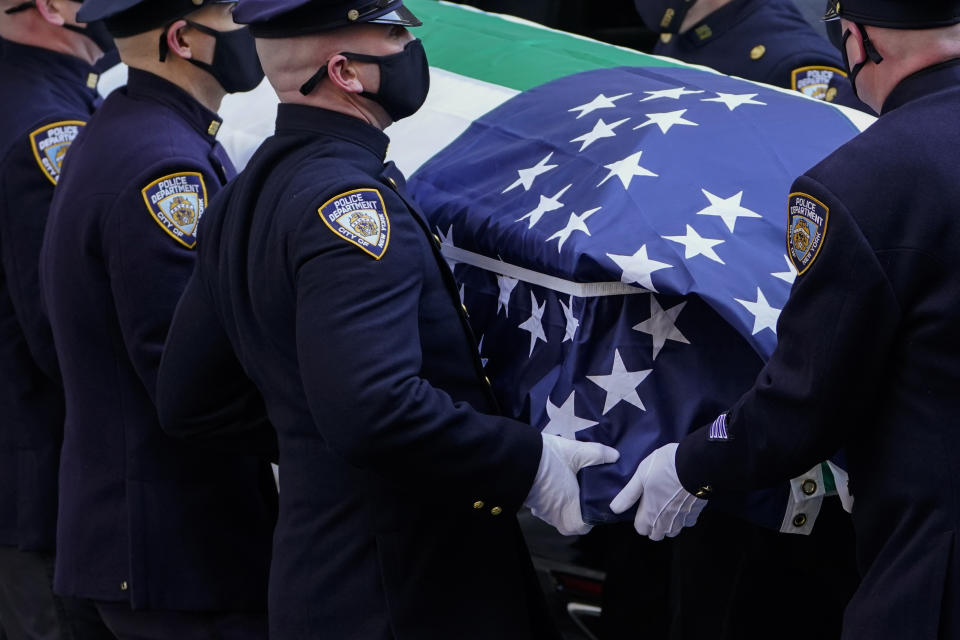 The casket of New York City Police Officer Wilbert Mora is delivered to St. Patrick's Cathedral for his wake, Tuesday, Feb. 1, 2022, in New York. Mora and Officer Jason Rivera were fatally wounded when a gunman ambushed them in an apartment as they responded to a family dispute. (AP Photo/John Minchillo)