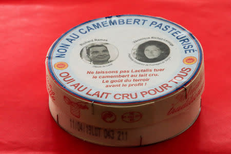 A box of a non-pasteurized French Camembert cheese with the pictures of French deputy Richard Ramos and Veronique Richez-Lerouge, President of Fromages de Terroirs, is seen at the National Assembly in Paris, France, March 13, 2019. REUTERS/Gonzalo Fuentes