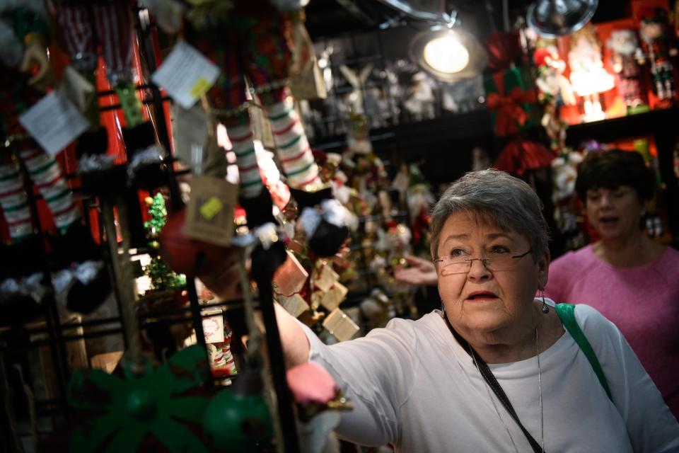 A shopper looks through items at the Culbreth & Co. booth at the 53rd annual Holly Day Fair on Nov. 8, 2019, at the Crown Expo Center.