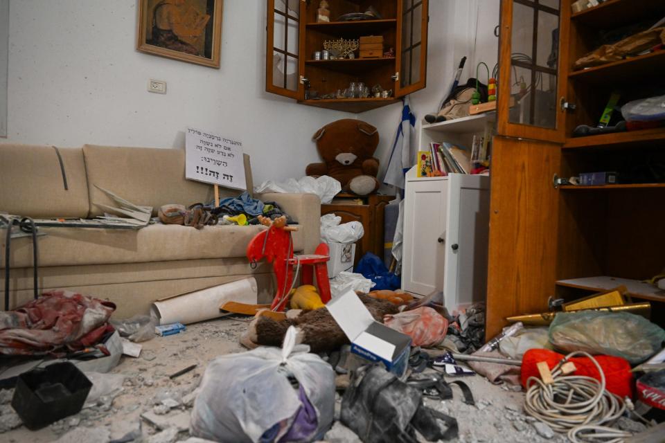 Family belongings including teddy bears, and the Judaica shelf at a home in Kibbutz Be'eri near the Gaza border after Hamas militants attacked on October 7.