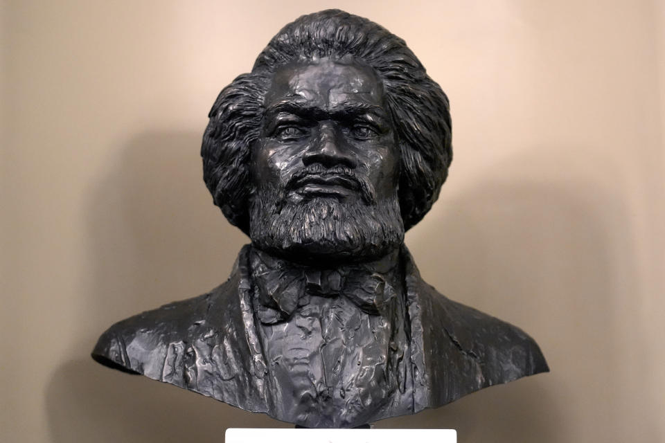 A bust of famed abolitionist Frederick Douglass, by artist Lloyd Lillie, rests in the Senate Chamber after is was unveiled during ceremonies, Wednesday, Feb. 14, 2024, at the Massachusetts Statehouse, in Boston. It's the first bust of an African American to be permanently added to the Mass. Statehouse, and the first bust to be added to the Senate Chamber in more than 125 years. (AP Photo/Steven Senne)