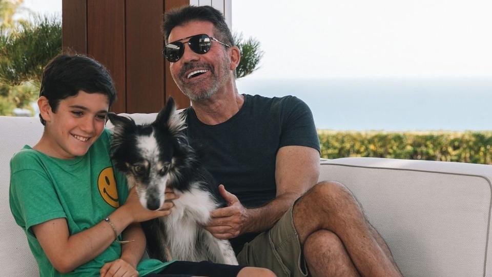 Simon Cowell and his son cuddling a dog