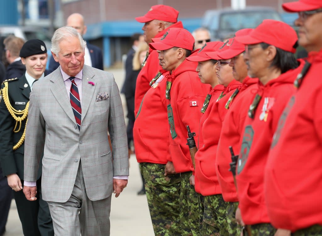 The Prince of Wales tried out a snowmobile for size and marvelled at its modern creature comfort of heated handles when he met Canadian Rangers (Chris Jackson/PA) (PA Archive)