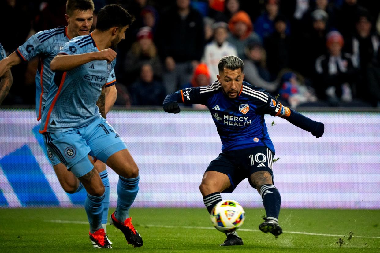 FC Cincinnati midfielder Luciano Acosta (10) takes a shot as New York City FC defender Thiago Martins (13) guards in the first half of the match between FC Cincinnati and New York City FC at in Cincinnati on Saturday, March 23, 2024.