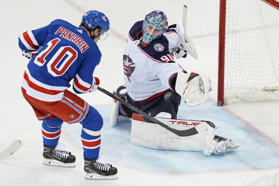 Columbus Blue Jackets goaltender Elvis Merzlikins (90) stops a shot by New York Rangers' Artemi Panarin (10) during the third period of an NHL hockey game Wednesday, Feb. 28, 2024, in New York. (AP Photo/Frank Franklin II)