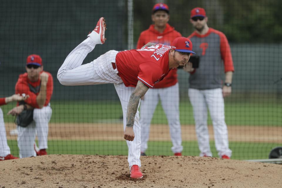 Philadelphia Phillies' Vince Velasquez delivers a pitch during a spring training baseball workout Wednesday, Feb. 19, 2020, in Clearwater, Fla. (AP Photo/Frank Franklin II)