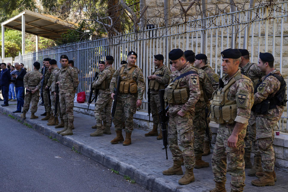 Lebanese army soldiers stand guard in front of the Justice Palace in Beirut, Lebanon, Thursday, March 16, 2023. Lebanon's embattled Central Bank chief, Riad Salameh, appeared Thursday for questioning for the first time before a European legal team visiting Beirut in a money-laundering probe linked to the governor. (AP Photo/Bilal Hussein)