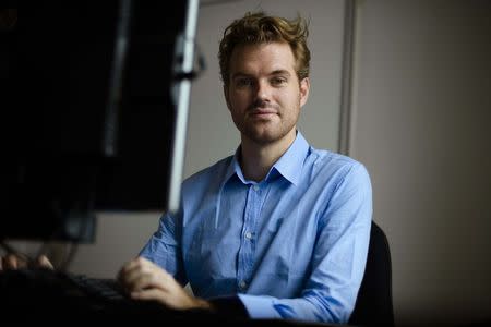 German crypto specialist and chief scientist with Berlin's SR Labs Karsten Nohl poses in his office in Berlin, July 30, 2014. REUTERS/Thomas Peter