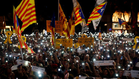 FILE PHOTO: People light up their mobile phones during a protest called by Catalan pro-independence movements ANC and Omnium Cultural to mark one year of the imprisonment of their leaders Jordi Sanchez and Jordi Cuixart, at Catalunya Square in Barcelona, Spain, Ocotber 16, 2018. REUTERS/Albert Gea/File Photo