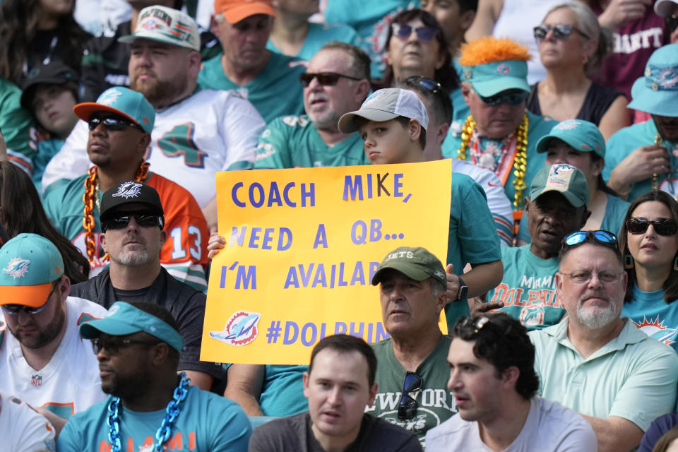 A Miami Dolphins fans offers his services during the first half of an NFL football game against the New York Jets, Sunday, Jan. 8, 2023, in Miami Gardens, Fla. (AP Photo/Lynne Sladky)