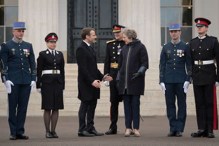 France's President Emmanuel Macron and Britain's Prime Minister Theresa May stand with British and French service personnel at Sandhurst Military Academy, Britain, January 18, 2018. REUTERS/Stefan Rousseau/Pool