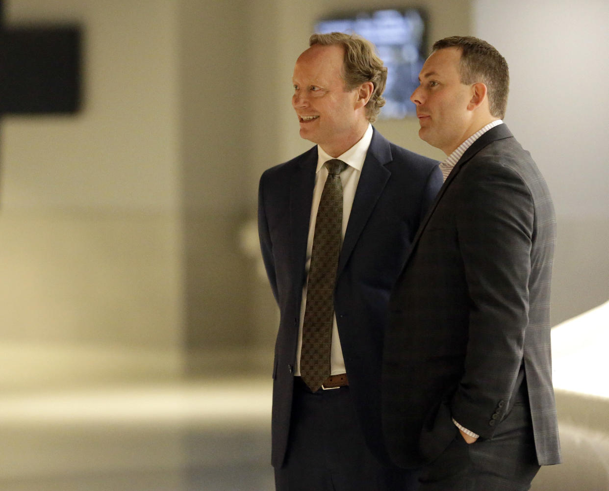 Milwaukee Bucks new head coach Mike Budenholzer speaks with general manager Jon Horst at a news conference in the team's new arena Monday, May 21, 2018, in Milwaukee. (AP Photo/Aaron Gash)