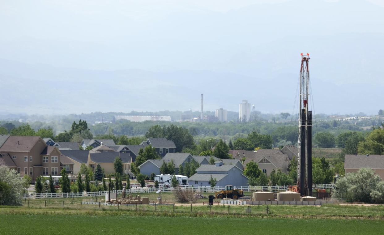 <span class="caption">Noise, pollution and other stressors from trucks and drilling can harm residents' health. In Colorado, an upcoming vote on new setback rules is expected to widen the buffer zone.</span> <span class="attribution"><a class="link " href="https://www.gettyimages.com/detail/photo/homes-and-natural-gas-drill-rig-frederick-colorado-royalty-free-image/181097775" rel="nofollow noopener" target="_blank" data-ylk="slk:Milehightraveler/iistock via Getty;elm:context_link;itc:0;sec:content-canvas">Milehightraveler/iistock via Getty</a></span>