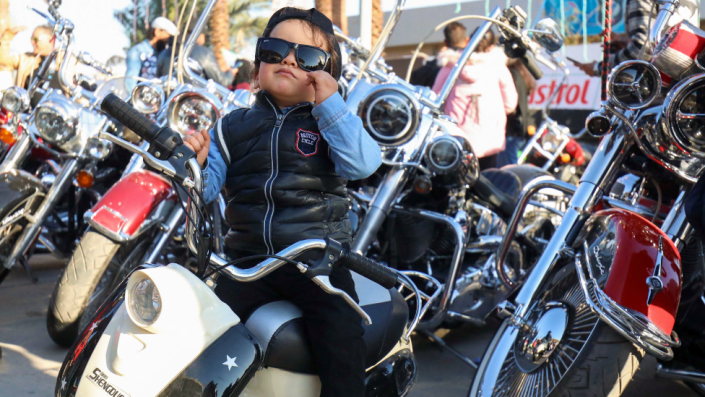 A boy in sunglasses sits on a motorbike at an event organised by the Benghazi Motorcycles Club in Benghazi, Libya - Tuesday 15 March 2022