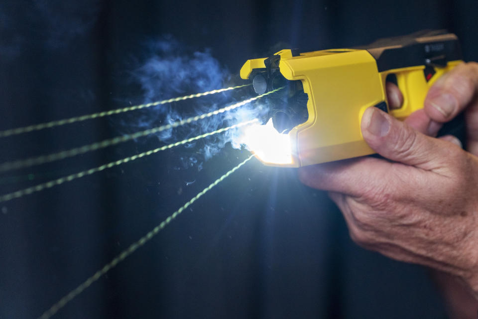 A representative for Axon Enterprise Inc. demonstrates the company's TASER 7 in Washington on Thursday, May 12, 2022. (AP Photo/Jacquelyn Martin)