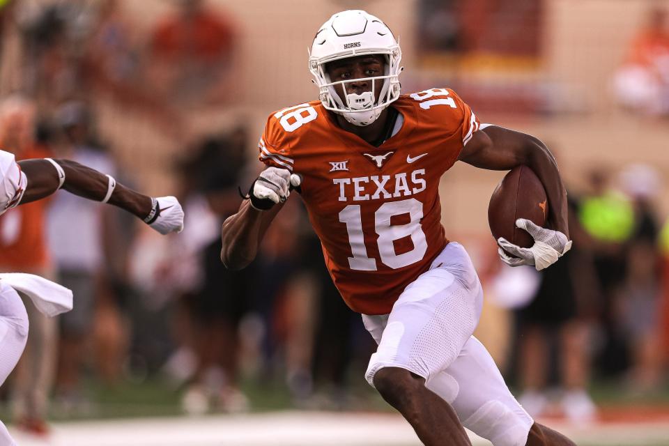 Texas wide receiver Isaiah Neyor (18) runs the ball during Texas's annual spring football game at Royal Memorial Stadium in Austin, Texas on April 23, 2022.