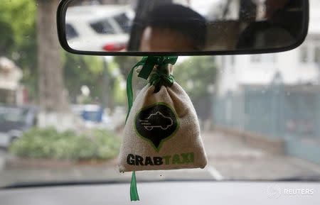 A sachet with the GrabTaxi logo is seen in a car in Hanoi, Vietnam September 9, 2015. REUTERS/Kham