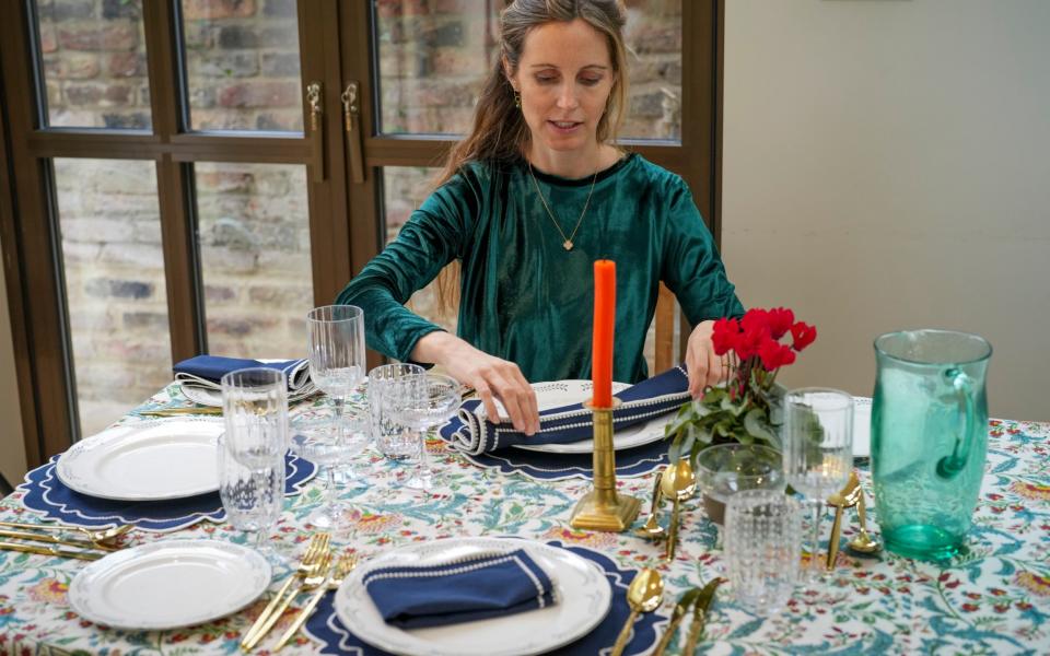 Anna laying the table with hired decorations, crockery and cutlery - Andrew Crowley