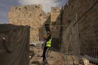 A worker places netting at a construction site inside the Tower of David Museum in the Old City of Jerusalem, Wednesday, Oct. 28, 2020. Jerusalem's ancient citadel is devoid of tourists due to the pandemic and undergoing a massive restoration and conservation project. The Tower of David, the Old City's iconic fortress, contains remnants of successive fortifications built one atop the other stretching back over 2,500 years. (AP Photo/Maya Alleruzzo)