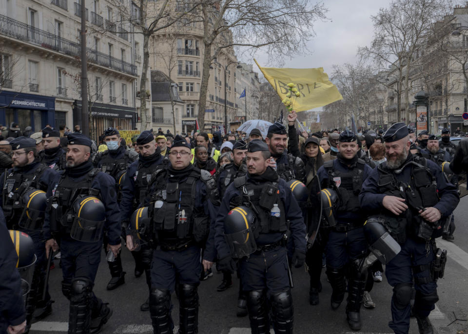 Demonstrators, in opposition to vaccine pass and vaccinations to protect against COVID-19 shout slogans during a rally in Paris, France, Saturday, Jan. 22, 2022. (AP Photo/Rafael Yaghobzadeh)