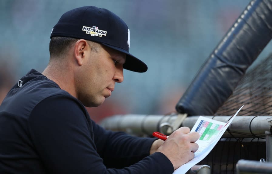 Oct 20, 2022; Houston, Texas, USA; New York Yankees hitting coach Dillon Lawson takes notes before game two of the ALCS against the New York Yankees for the 2022 MLB Playoffs at Minute Maid Park.