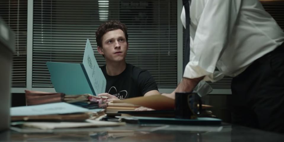 spider man appearing concerned while looking up with a folder in his hands