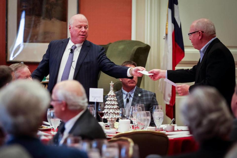 George Young Jr., chairman of the luncheon and chief extractor, hands a check to Jim Eagle during Exchange Club Luncheon honoring the Goodfellows Fund Wednesday, Nov. 8, 2021, at Fort Worth Club.