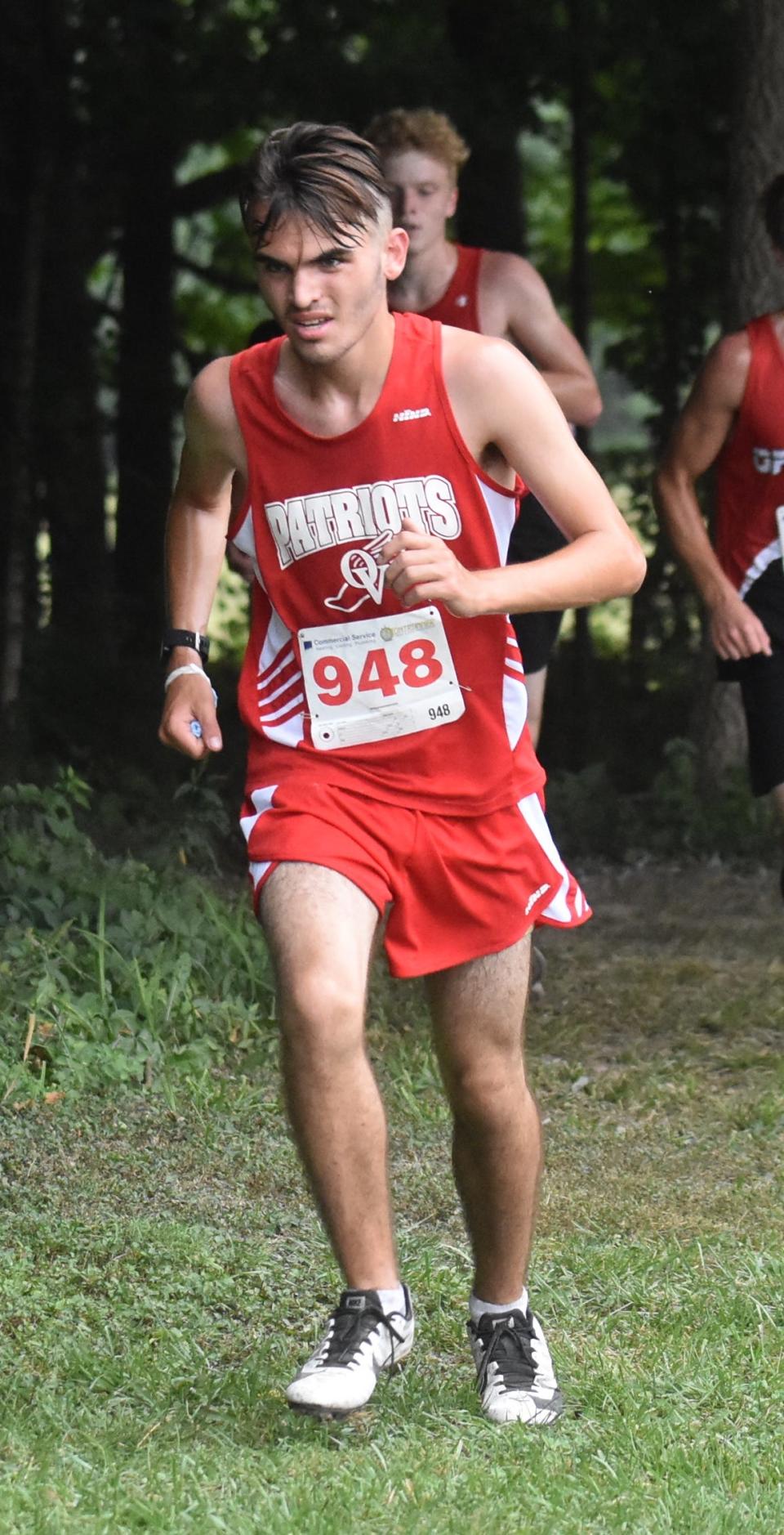 Tristan Calvin runs during his freshman year at Owen Valley High School.