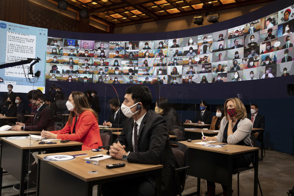 Journalists attend at an on-line New Year press conference by South Korean President Moon Jae-in at the Presidential Blue House in Seoul, South Korea Monday, Jan. 18, 2021. (Jeon Heon-kyun/Pool Photo via AP)