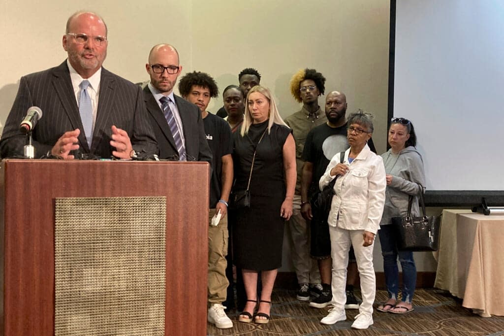 Attorney Rex Elliott addresses reporters with the extended family of Donovan Lewis behind him, on Thursday, Sept. 1, 2022, in Columbus. Ohio. (AP Photo/Andrew Welsh-Huggins)