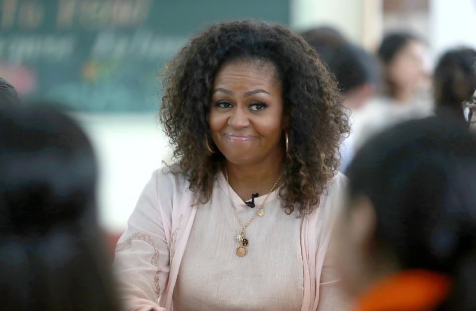 Former U.S. first lady Michelle Obama reacts as she listens to female students at Can Giuoc high school in Long An province, Vietnam on Monday, Dec. 9, 2019. Mrs. Obama is on a visit to Vietnam to promote education for adolescent girls. (AP Photo/Hau Dinh)