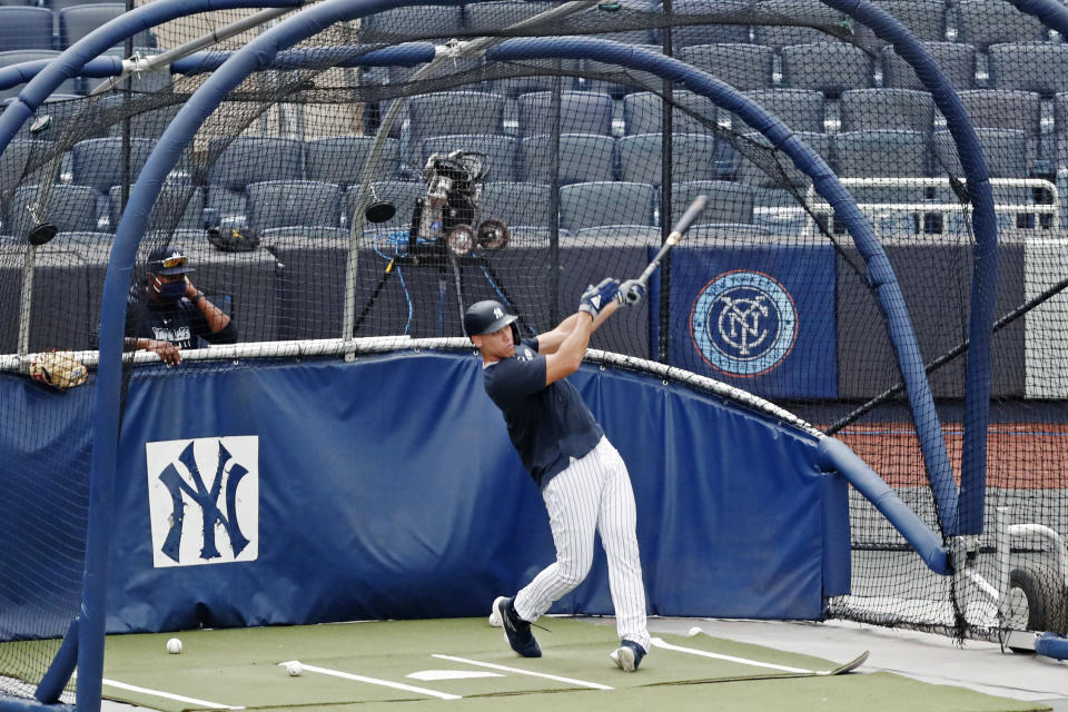 New York Yankees hitting coach Marcus Thames, left, watches Aaron Judge take batting practice during a baseball summer training camp workout, Wednesday, July 8, 2020, at Yankee Stadium in New York. (AP Photo/Kathy Willens)