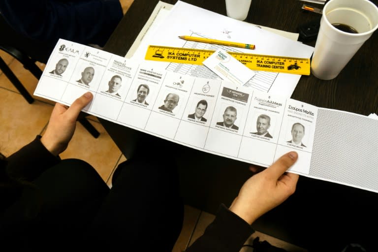 A picture taken on January 18, 2018, shows a list of all candidates in the Cypriot presidential elections in the Cypriot port city of Larnaca