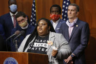 Zyahna Bryant, front, a student activist and community organizer who wrote a 2016 petition calling on the Charlottesville City Council to remove a statue of Confederate Gen. Robert E. Lee from a downtown park, was among those who joined Gov. Ralph Northam, right, Richmond Mayor Levar Stoney, second from right, and Rev. Robert W. Lee, IV, second from left, during a news conference Thursday June. 4, 2020, in Richmond, Va. A towering statue of Confederate Gen. Robert E. Lee will be removed as soon as possible from Richmond's Monument Avenue, Gov. Northam said Thursday, pledging the state will no longer “preach a false version of history.” (AP Photo/Steve Helber)