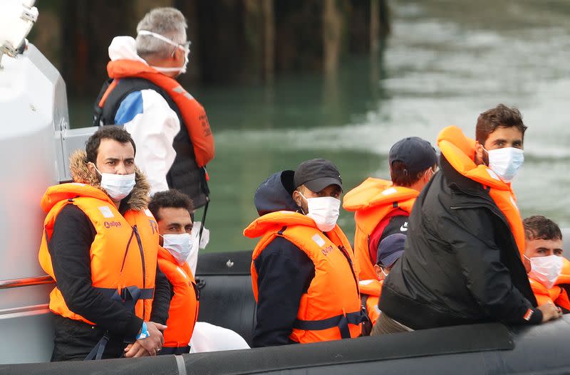 Migrants react as they are brought to Dover harbour by Border Patrol, in Dover