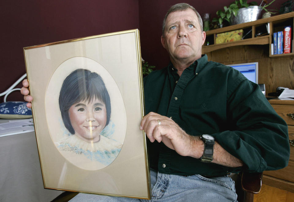 Image: Jerry Ensminger holds a portrait of his daughter, Janey, who died of leukemia at age 9, in 2007. (Gerry Broome / AP file)