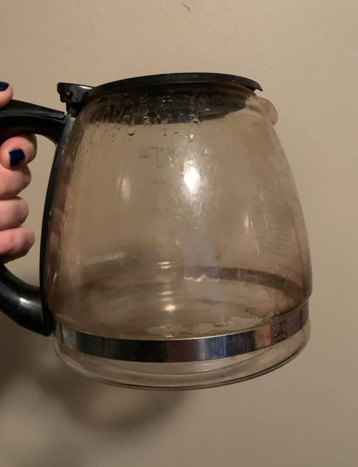 A Reddit user asks for advice on cleaning a stained coffee pot in the CleaningTips subreddit. Commenters provide various tips and solutions