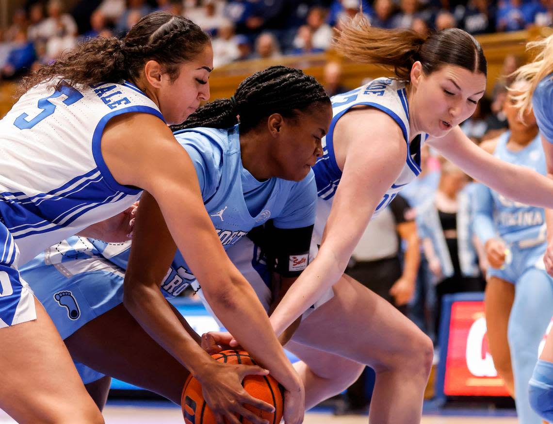 Duke’s Taya Corosdale and Mia Heide fight for a loose ball with North Carolina’s Anya Poole during the first half of the Tar Heels’ 45-41 win over Duke on Sunday, Feb. 26, 2023, at Cameron Indoor Stadium in Durham, N.C.