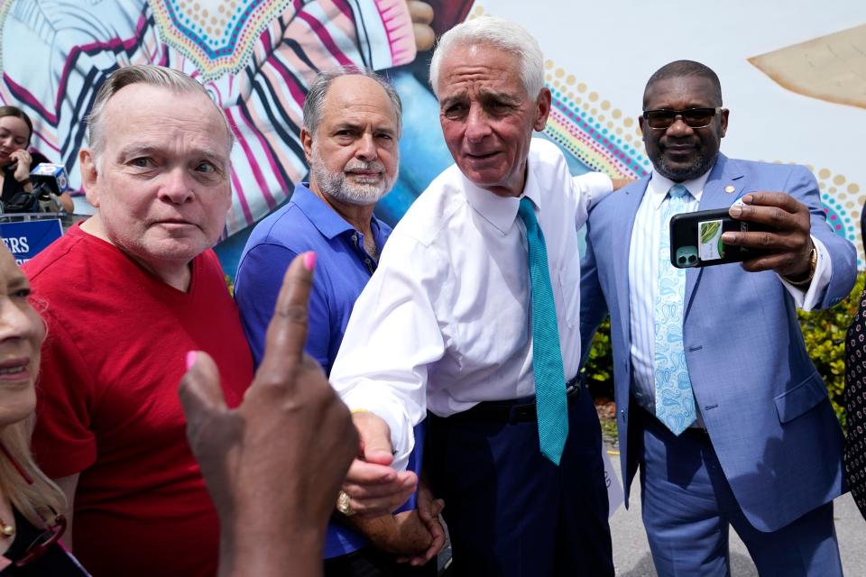 Rep. Charlie Crist, D-Fla., second from right, talks with a supporter outside of the United Teachers of Dade offices, May 31, 2022, in Miami Springs, Fla.
