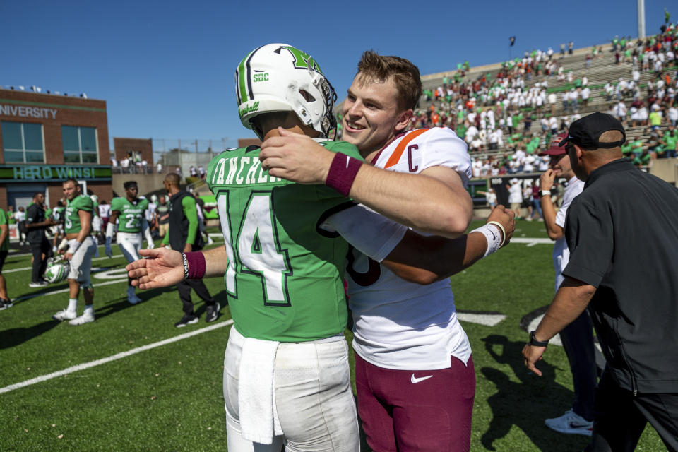 Marshall quarterback Cam Fancher greets Virginia Tech and former Herd quarterback Grant Wells after an NCAA college football game, Saturday, Sept. 23, 2023, at Joan C. Edwards Stadium in Huntington, W.Va. (Sholten Singer/The Herald-Dispatch via AP)