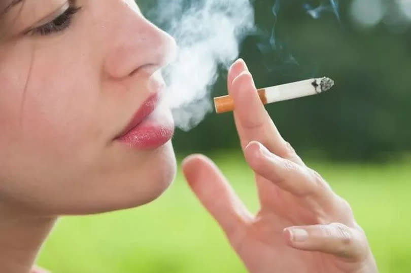 A young woman smoking a cigarette