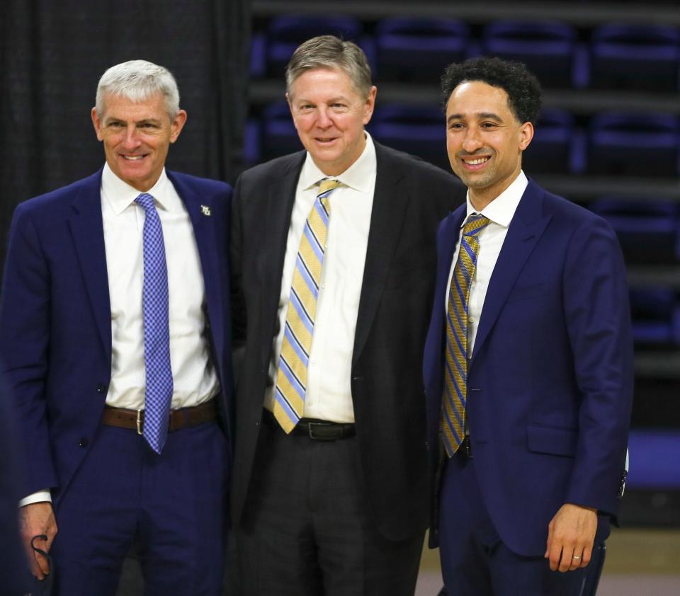 Athletic director Bill Scholl, along with Marquette President Michael Lovell, hired men's basketball coach Shaka Smart in 2021.