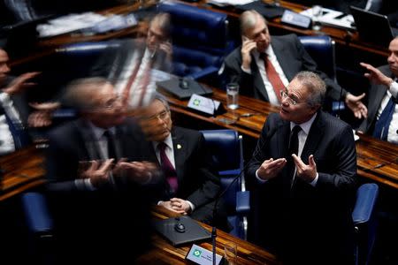 Brazil's Senate President Renan Calheiros gestures, as he is reflected in glass, during the final session of debate and voting on suspended President Dilma Rousseff's impeachment trial in Brasilia, Brazil August 26, 2016. REUTERS/Ueslei Marcelino