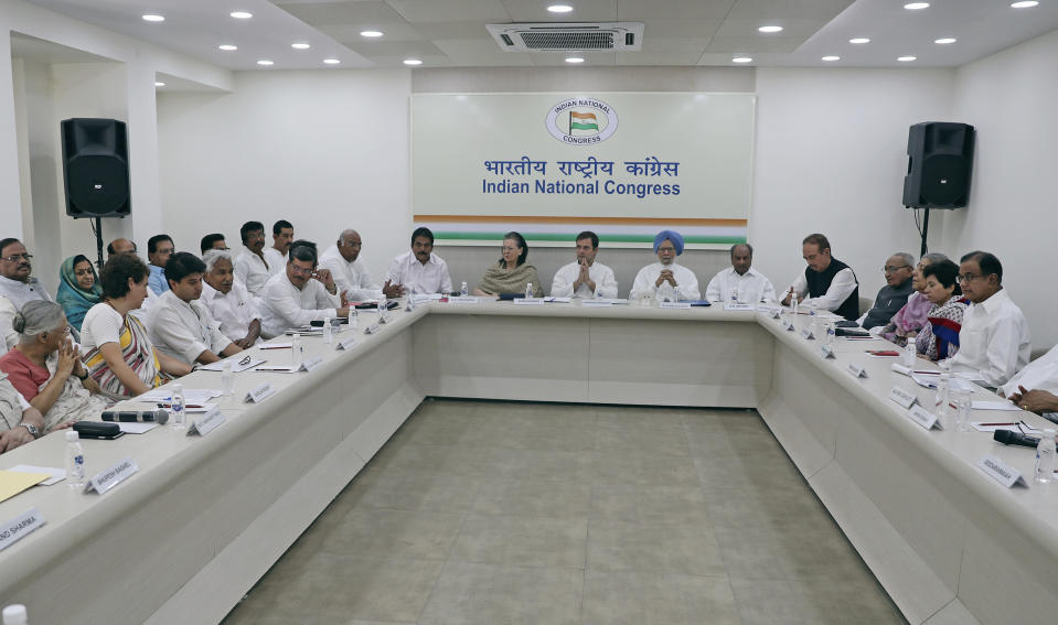 Congress party leaders Sonia Gandhi, center left, her son and party President Rahul Gandhi, center, former Indian Prime Minister Manmohan Singh, center right, and others attend a Congress Working Committee meeting in New Delhi, India, Saturday, May 25, 2019. The BJP's top rival, led by Rahul Gandhi, won 52 seats out of 542 seats in the Lok Sabha, the lower house of Parliament, after the official vote count finished Friday. (AP Photo/Altaf Qadri)