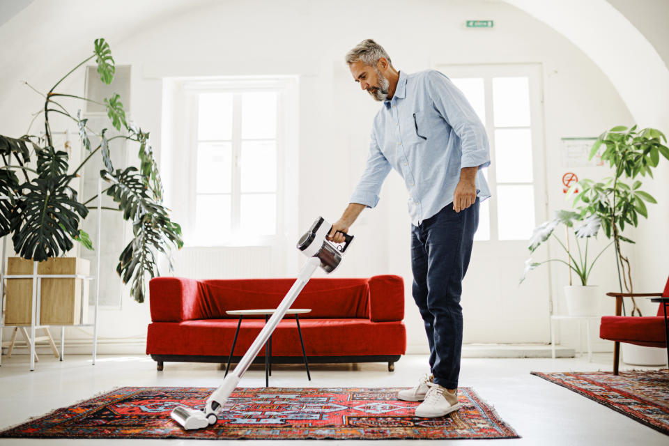 person vacuuming their living room